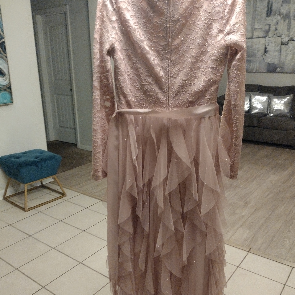 After dress short in the font long in the back with glitter all over it. V neck